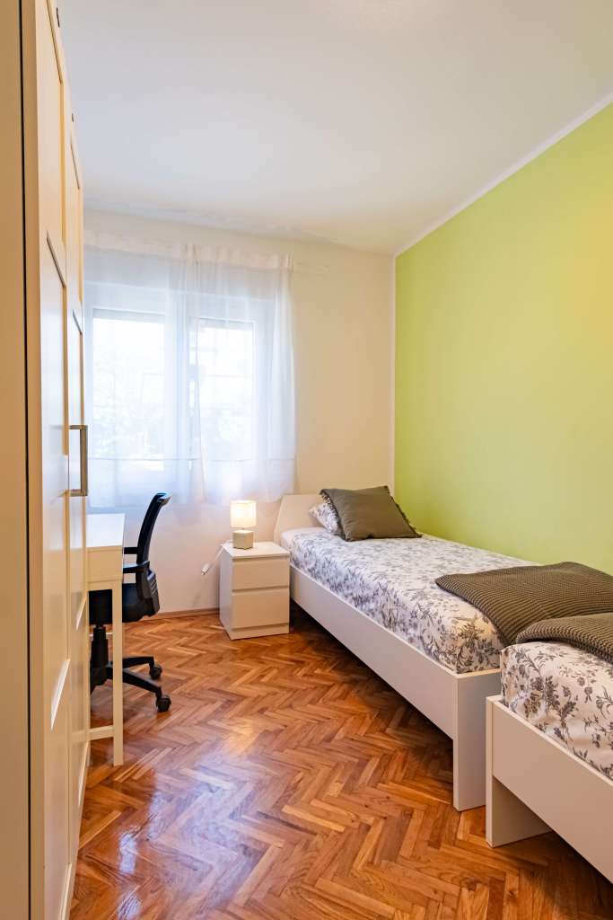 Lmpuga Fitness Camp bedroom with two single-beds