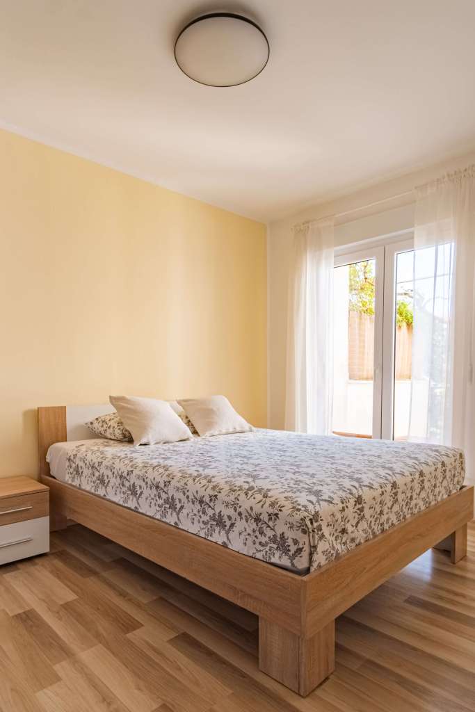 Lampuga Fitness Camp bedroom with king-size bed